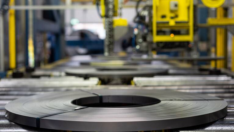 Flat rolled wire coil on a rolling conveyor at the plant in Italy
